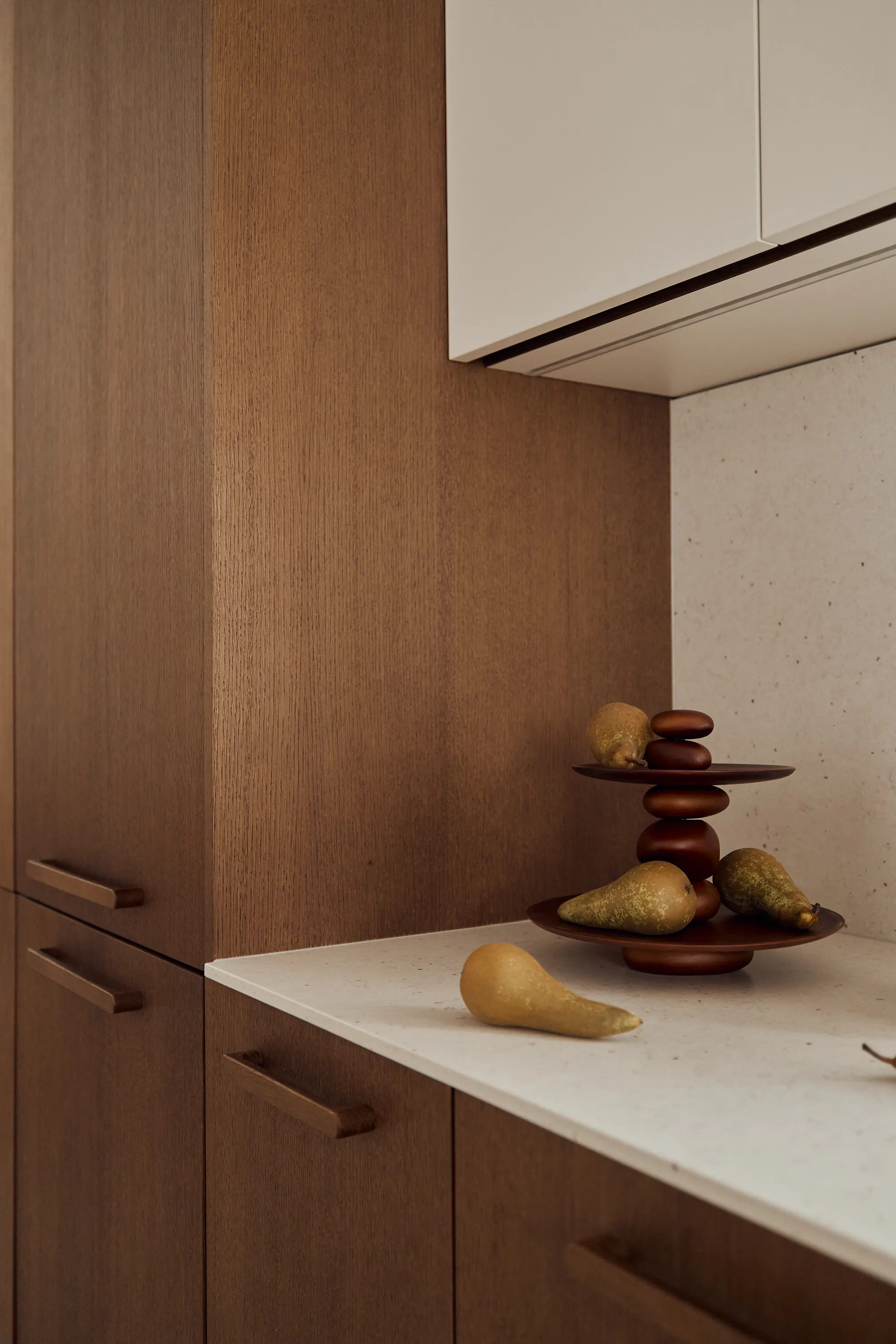 Brown oak kitchen with burgundy hood and hand-selected Italian hardware