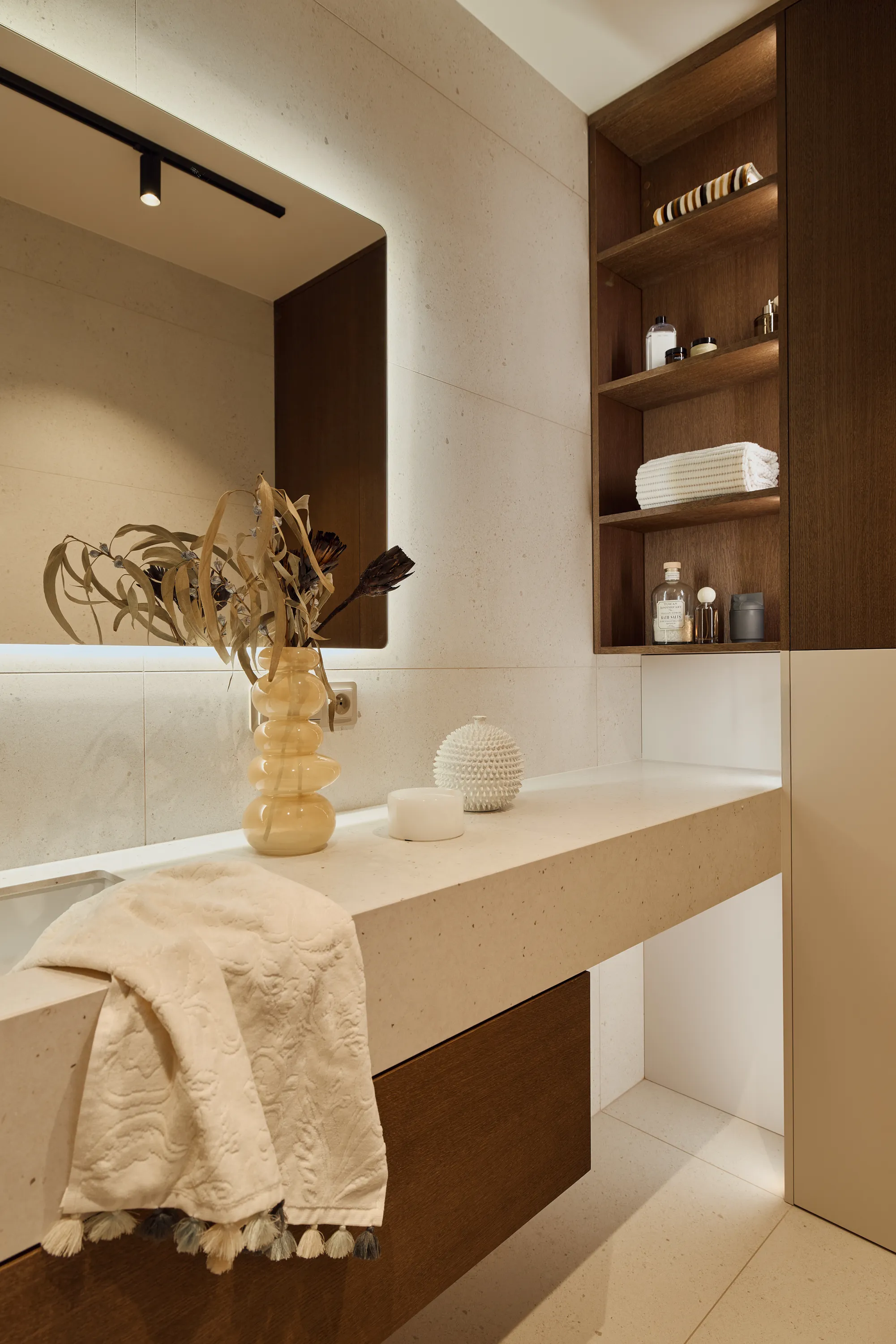 Brown oak cabinetry with curved island and refined burgundy accents