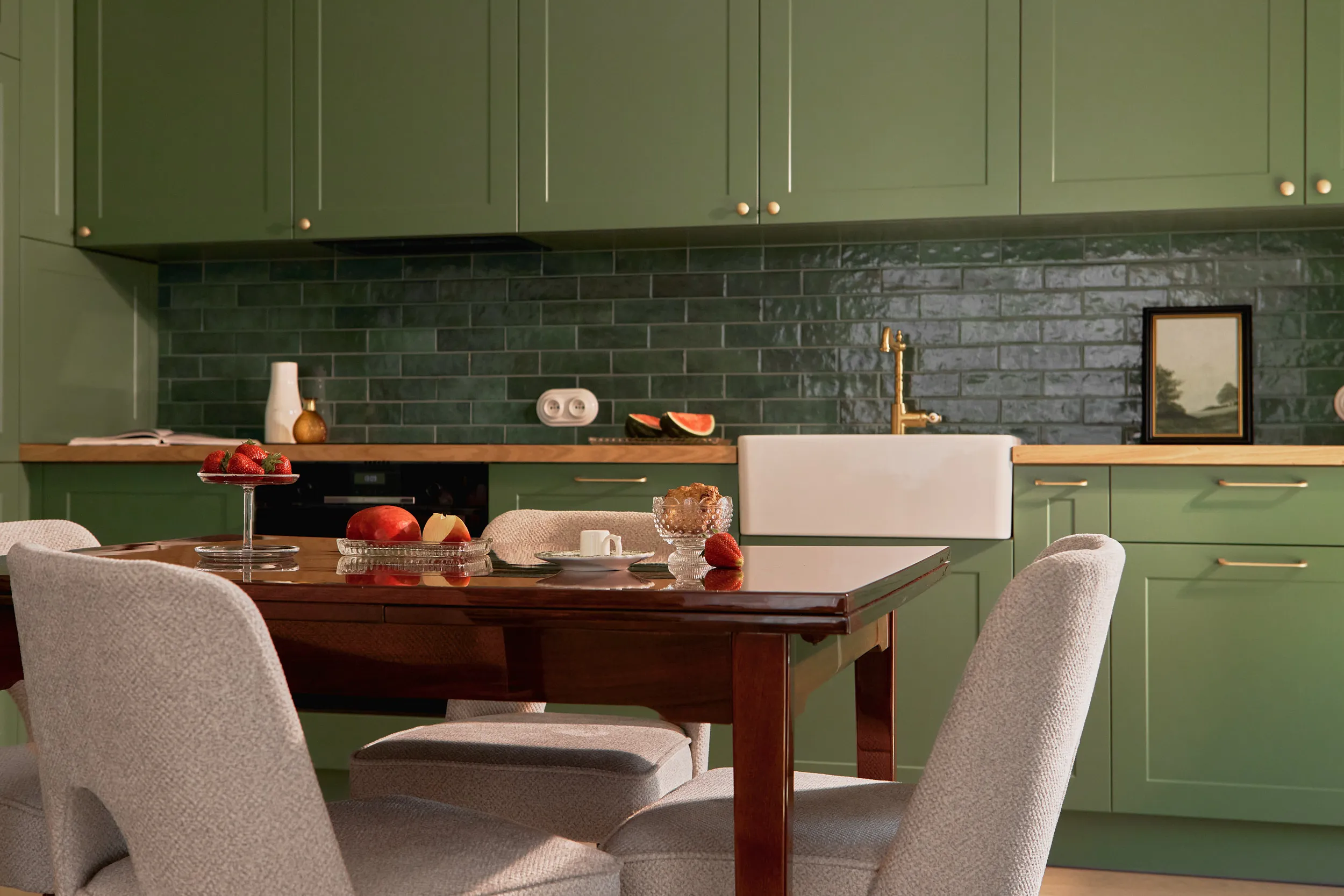 Sage green kitchen detail with butcher block and reeded glass